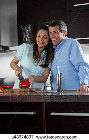 couple cooking in the kitchen View Large Photo Image Stock Photo - couple cooking in the kitchen. Fotosearch