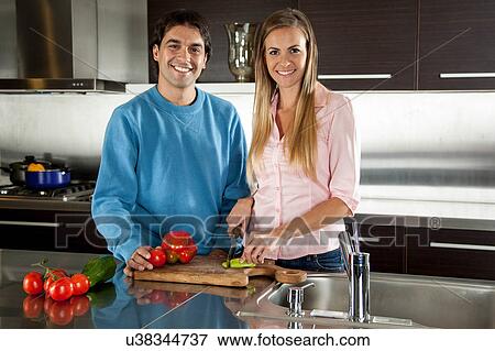 couple cutting vegetables View Large Photo Image Stock Photo - couple cutting vegetables. Fotosearch