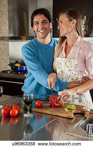 Stock Photo - couple cutting vegetables. Fotosearch