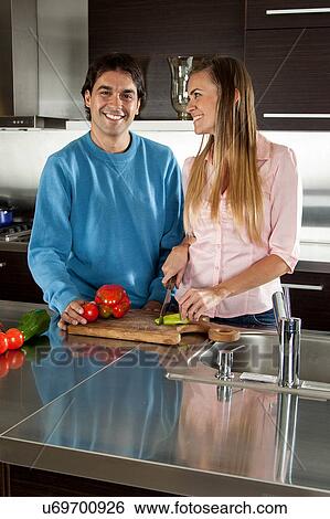 Stock Photograph - couple cutting vegetables. Fotosearch