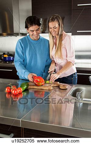 couple cutting vegetables View Large Photo Image Stock Photography - couple cutting vegetables. Fotosearch