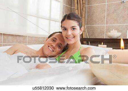 Stock Image - Couple enjoying the spaday in the tub. Fotosearch