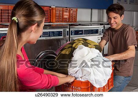 Stock Photo - Couple fighting over clothes. Fotosearch