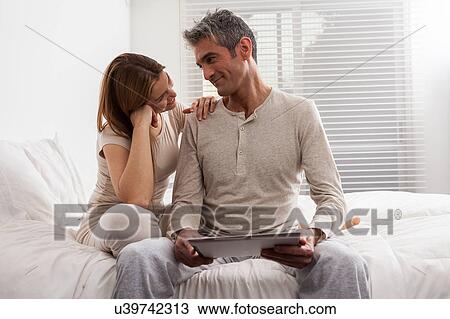 Couple having fun with the ipad View Large Photo Image Stock Image - Couple having fun with the ipad. Fotosearch