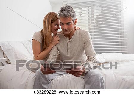 Stock Photo - Couple in bed. Fotosearch