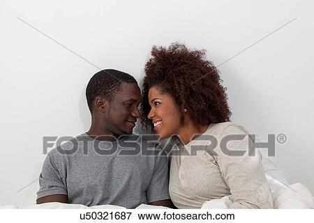 Stock Photo - Couple in love looking each other. Fotosearch
