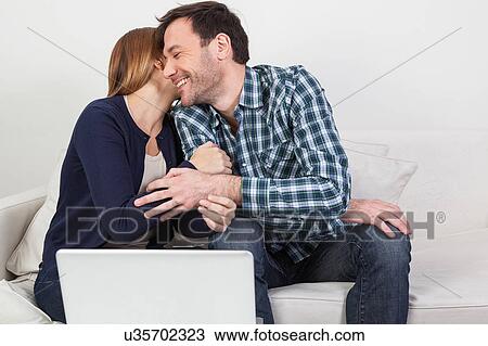 Stock Image - Couple in love playing the computer. Fotosearch