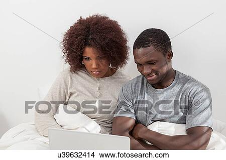 Couple in love using the computer View Large Photo Image Picture - Couple in love using the computer. Fotosearch