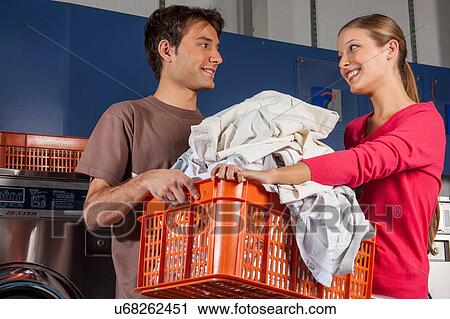 Stock Image - Couple in the laundry. Fotosearch