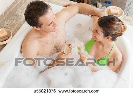 Couple in the tub toasting View Large Photo Image Stock Photograph - Couple in the tub toasting. Fotosearch