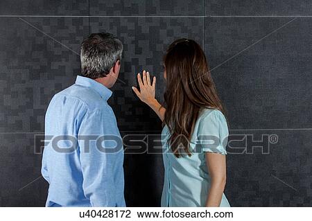 couple looking at the wall View Large Photo Image Stock Image - couple looking at the wall. Fotosearch