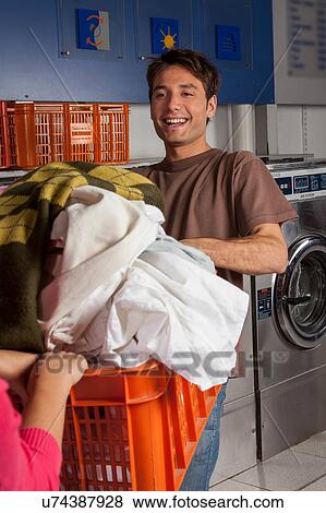 Stock Photo - Couple playing in the laundry. Fotosearch