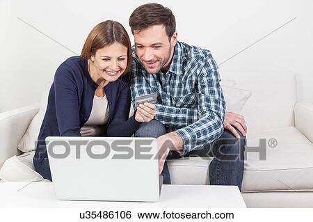 Couple shopping online View Large Photo Image Stock Photograph - Couple shopping online. Fotosearch