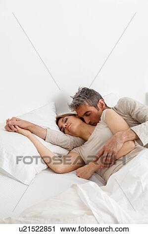 Couple sleeping in his bed View Large Photo Image Stock Image - Couple sleeping in his bed. Fotosearch