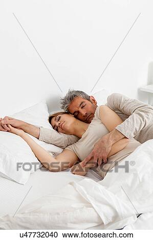 Couple sleeping in his bed View Large Photo Image Stock Image - Couple sleeping in his bed. Fotosearch
