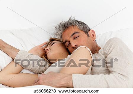 Couple sleeping in his bed View Large Photo Image Stock Photo - Couple sleeping in his bed. Fotosearch