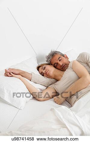 Couple sleeping in his bed View Large Photo Image Stock Photo - Couple sleeping in his bed. Fotosearch
