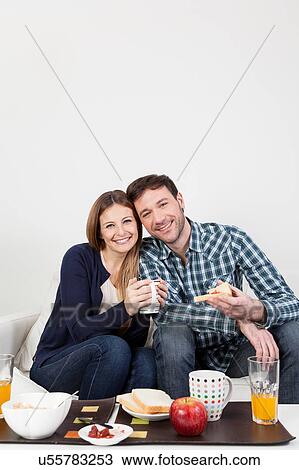 Stock Image - Couple smiling having a breakfast. Fotosearch