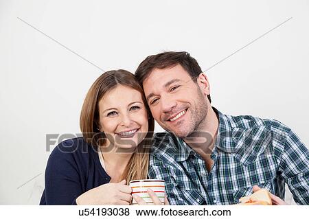Couple smiling in breakfast View Large Photo Image Stock Photo - Couple smiling in breakfast. Fotosearch