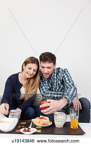 Couple smiling in breakfast View Large Photo Image Stock Photograph - Couple smiling in breakfast. Fotosearch