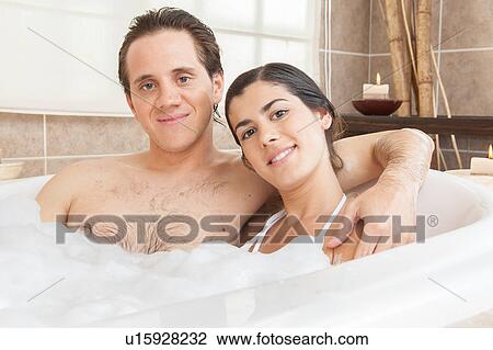 Stock Image - Couple smiling in the tub. Fotosearch