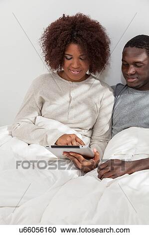 Stock Image - Couple using the computer. Fotosearch