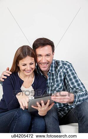 couple using the ipad View Large Photo Image Stock Image - couple using the ipad. Fotosearch