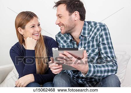couple using the ipad View Large Photo Image Stock Photo - couple using the ipad. Fotosearch