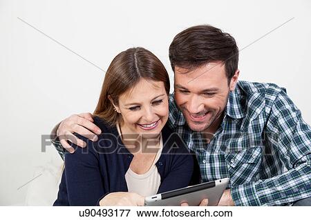 Stock Photo - couple using the ipad. Fotosearch