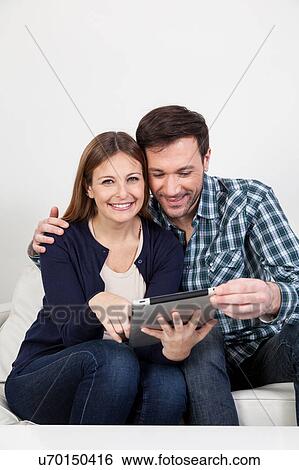 couple using the ipad View Large Photo Image Stock Photograph - couple using the ipad. Fotosearch