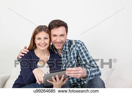 Stock Photography - couple using the ipad. Fotosearch