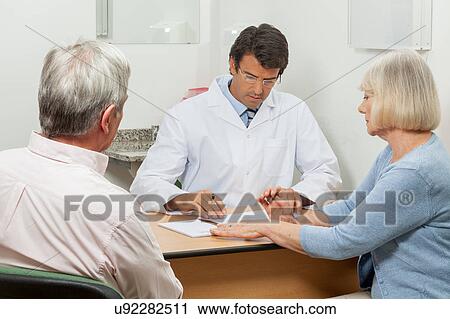 Stock Image - Couple visiting the doctor. Fotosearch