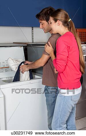 Couple washing clothes in the laundry View Large Photo Image Stock Photo - Couple washing clothes in the laundry. Fotosearch