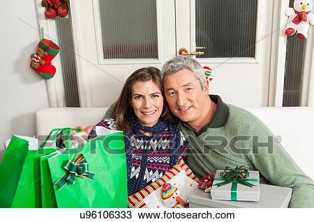 Couple with presents for christmas View Large Photo Image Stock Image - Couple with presents for christmas. Fotosearch