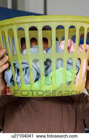 Stock Image - Covers his face with basket. Fotosearch