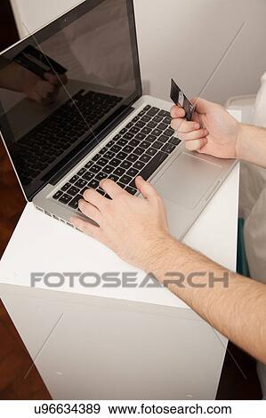 Stock Photo - Credit card and computer. Fotosearch