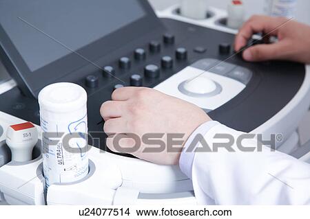 Picture - Doctor doing a doppler sonography. Fotosearch