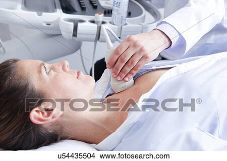 Doctor doing a doppler sonography View Large Photo Image Picture - Doctor doing a doppler sonography. Fotosearch