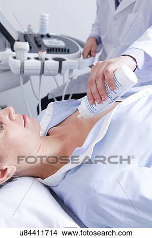 Picture - Doctor doing a doppler sonography. Fotosearch