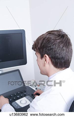Stock Image - Doctor doing a doppler sonography. Fotosearch
