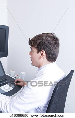 Stock Image - Doctor doing a doppler sonography. Fotosearch