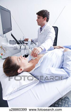 Stock Photo - Doctor doing a doppler sonography. Fotosearch