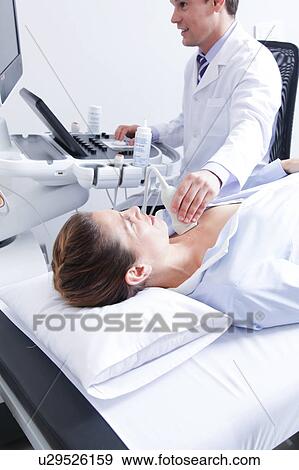 Stock Photo - Doctor doing a doppler sonography. Fotosearch