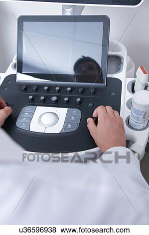Stock Photo - Doctor doing a doppler sonography. Fotosearch