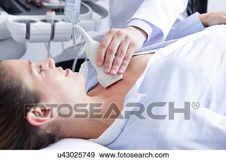 Stock Photo - Doctor doing a doppler sonography. Fotosearch