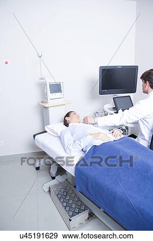 Stock Photo - Doctor doing a doppler sonography. Fotosearch