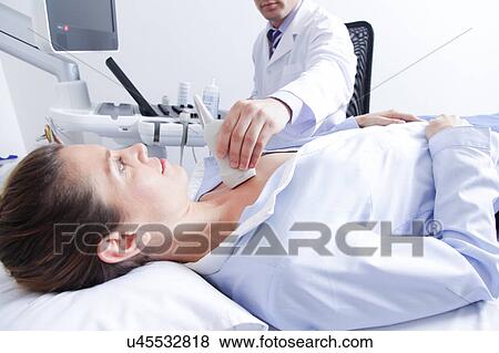 Stock Photo - Doctor doing a doppler sonography. Fotosearch