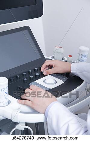 Stock Photo - Doctor doing a doppler sonography. Fotosearch