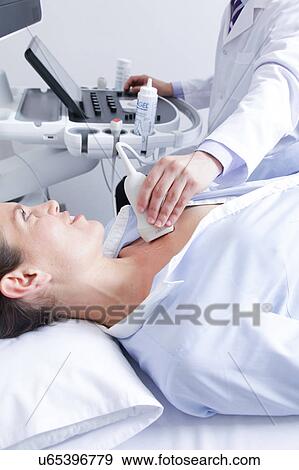 Stock Photo - Doctor doing a doppler sonography. Fotosearch