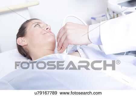 Stock Photo - Doctor doing a doppler sonography. Fotosearch